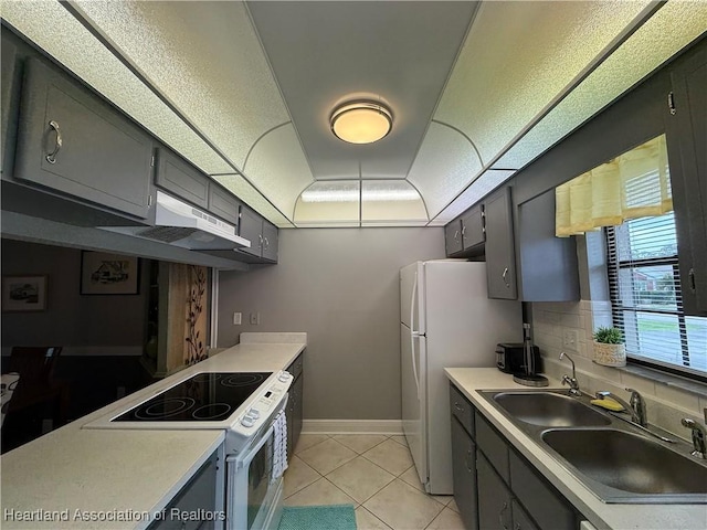 3711 Perugia Ave, Sebring, FL 33872 - kitchen featuring white appliances, a sink, gray cabinets, under cabinet range hood, and light tile patterned flooring