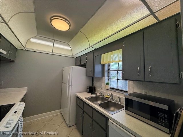 3711 Perugia Ave, Sebring, FL 33872 - kitchen with stainless steel microwave, a sink, range, tasteful backsplash, and light tile patterned floors