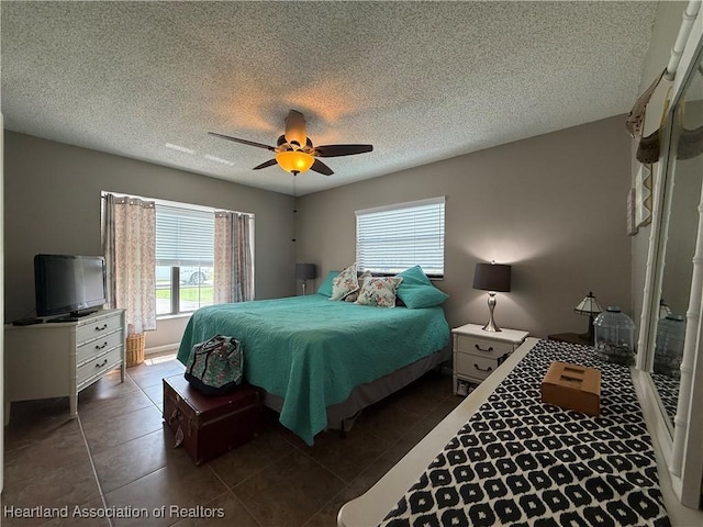 3711 Perugia Ave, Sebring, FL 33872 - bedroom featuring dark tile patterned floors, a ceiling fan, and a textured ceiling