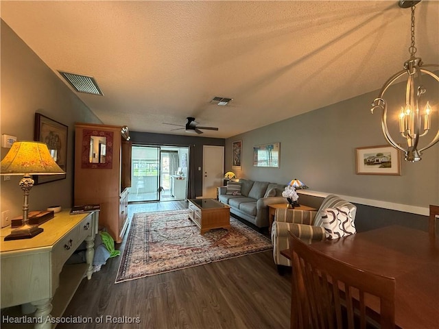 3711 Perugia Ave, Sebring, FL 33872 - living area featuring dark wood-type flooring, ceiling fan, a chandelier, and a textured ceiling