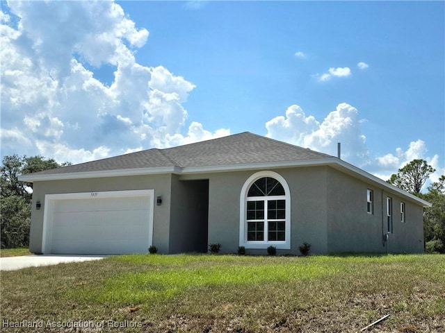 single story home featuring a front yard and a garage