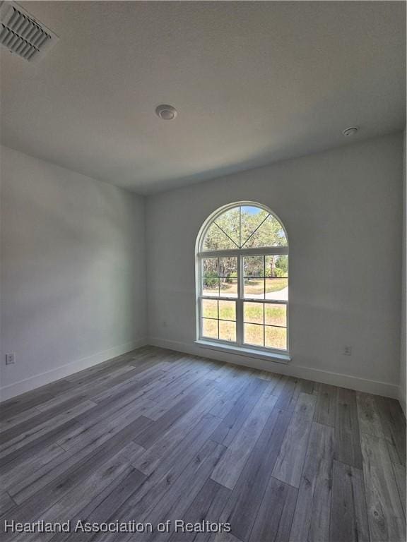 empty room with hardwood / wood-style floors