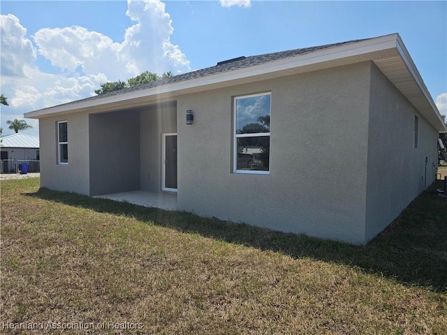 rear view of house with a lawn