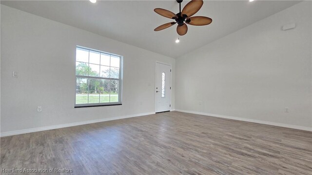 spare room with ceiling fan, lofted ceiling, and hardwood / wood-style floors