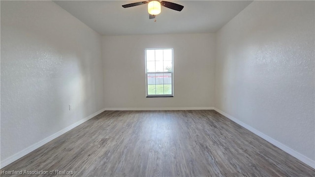 empty room featuring hardwood / wood-style flooring and ceiling fan