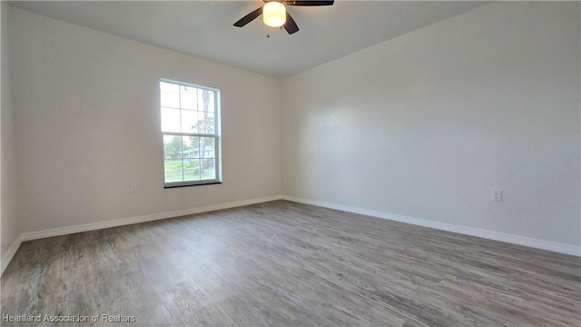 unfurnished room with hardwood / wood-style flooring and ceiling fan