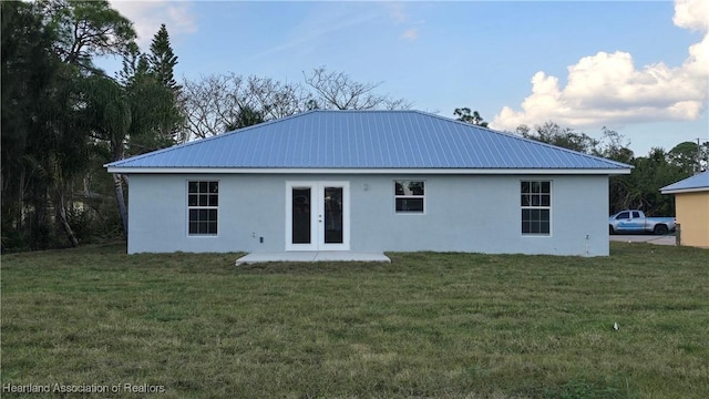 back of house featuring french doors and a yard