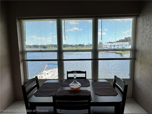 dining area with a textured wall and a water view