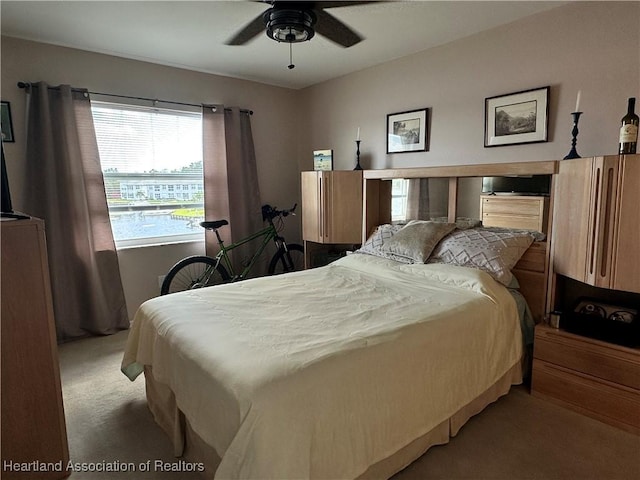 bedroom featuring light colored carpet and ceiling fan