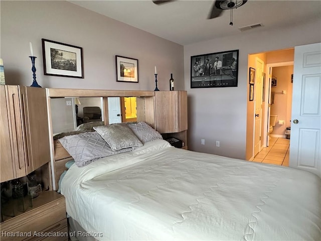 bedroom with tile patterned floors, ensuite bathroom, and visible vents