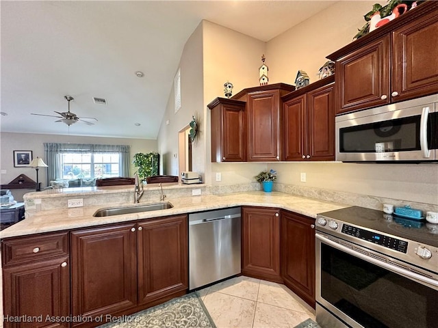 kitchen with kitchen peninsula, stainless steel appliances, light tile patterned floors, ceiling fan, and sink