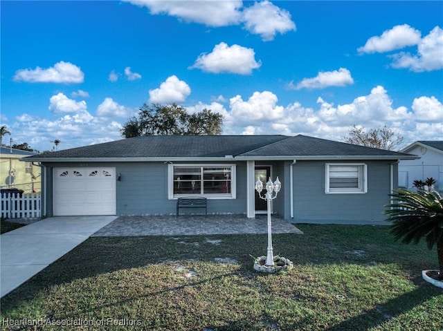 ranch-style home featuring a garage and a front lawn