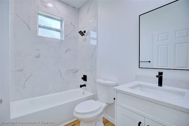 bathroom with toilet, vanity, bathtub / shower combination, and wood finished floors