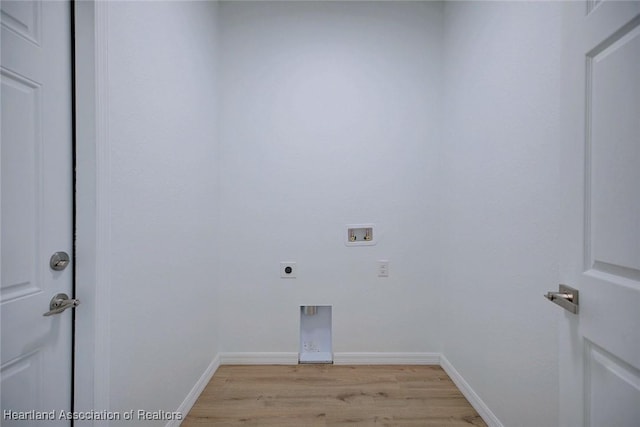 clothes washing area featuring light wood finished floors, washer hookup, hookup for an electric dryer, laundry area, and baseboards