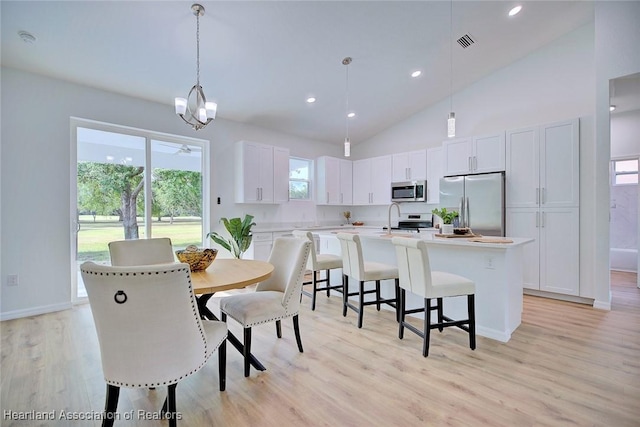 dining area with high vaulted ceiling, visible vents, baseboards, recessed lighting, and light wood-type flooring