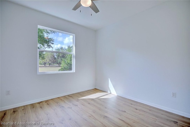 unfurnished room with baseboards, ceiling fan, and wood finished floors