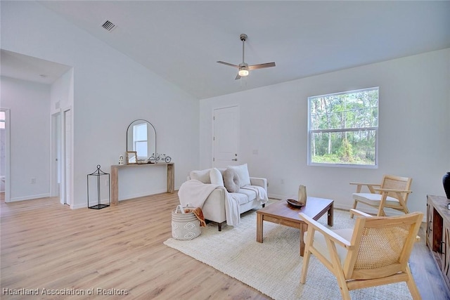 sitting room featuring baseboards, light wood-style flooring, visible vents, and a ceiling fan