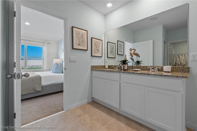 6856 Coconut Dr, Sebring, FL 33872 - bathroom with double vanity, connected bathroom, tile patterned flooring, baseboards, and recessed lighting