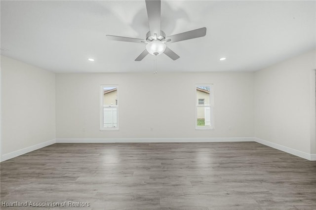 empty room featuring hardwood / wood-style flooring and ceiling fan