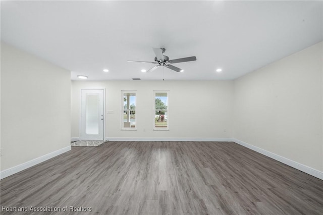 empty room featuring ceiling fan and dark hardwood / wood-style floors