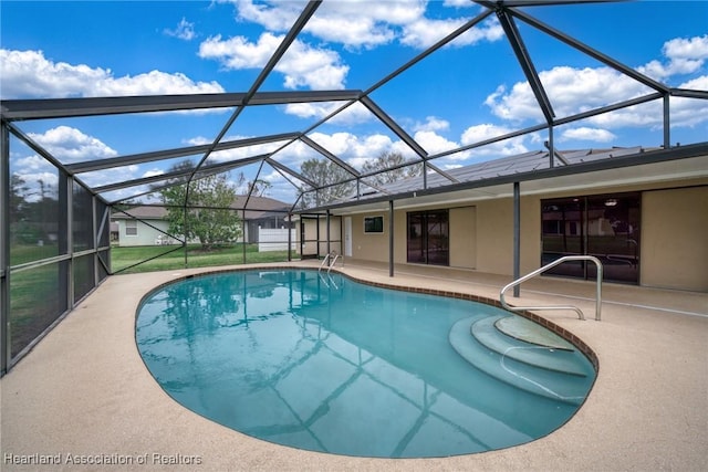 view of pool with a lanai and a patio area