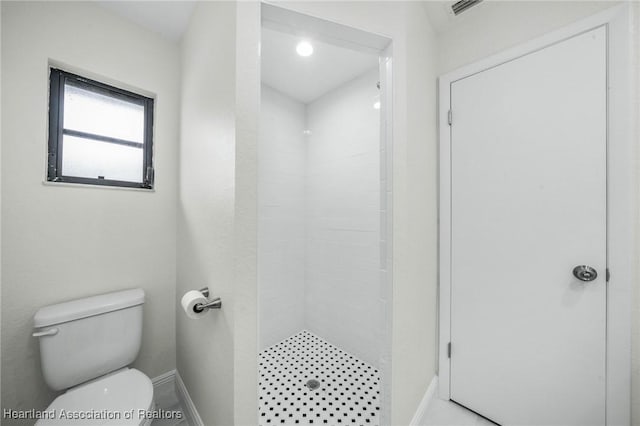 bathroom featuring toilet and a shower