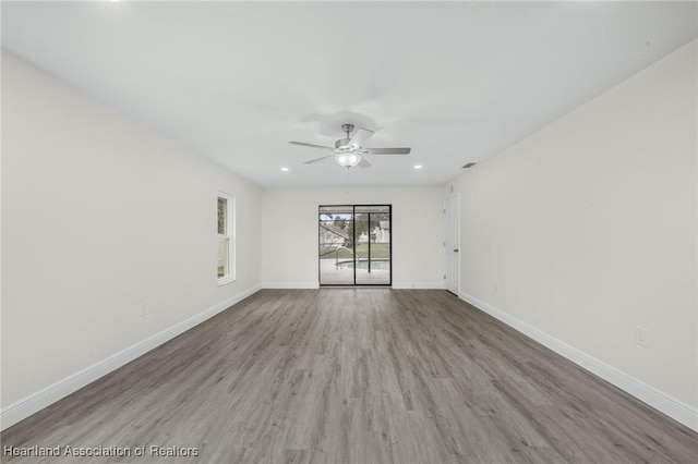 empty room featuring ceiling fan and light hardwood / wood-style flooring