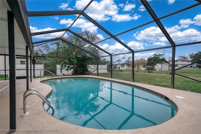 view of pool featuring a lawn, a lanai, and a patio