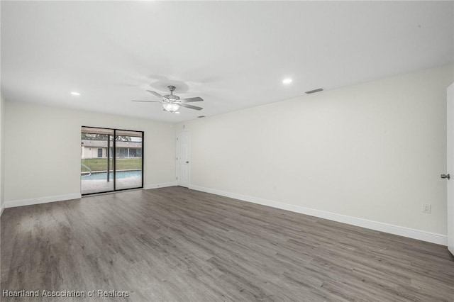 empty room featuring ceiling fan and hardwood / wood-style floors