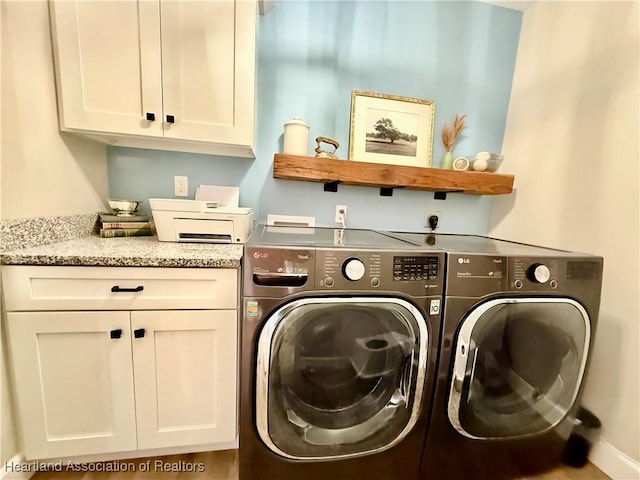 clothes washing area with cabinet space and washer and clothes dryer