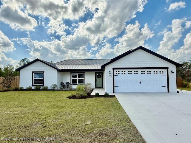 single story home with a garage, driveway, a front lawn, and metal roof