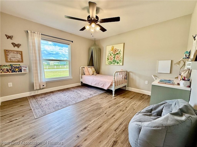 bedroom featuring wood finished floors and baseboards