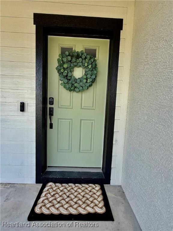 entrance to property with stucco siding