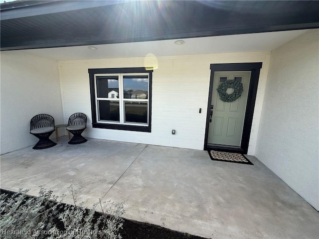 doorway to property with a patio and stucco siding