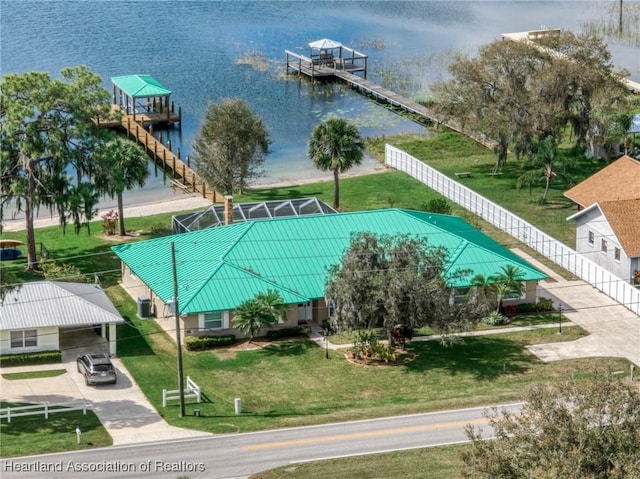 view of pool with a lawn, a water view, and a lanai