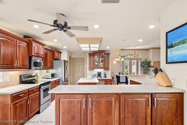 kitchen featuring french doors, appliances with stainless steel finishes, light countertops, decorative backsplash, and ceiling fan