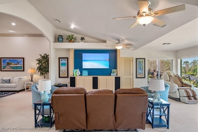 living area featuring vaulted ceiling, visible vents, arched walkways, and carpet floors