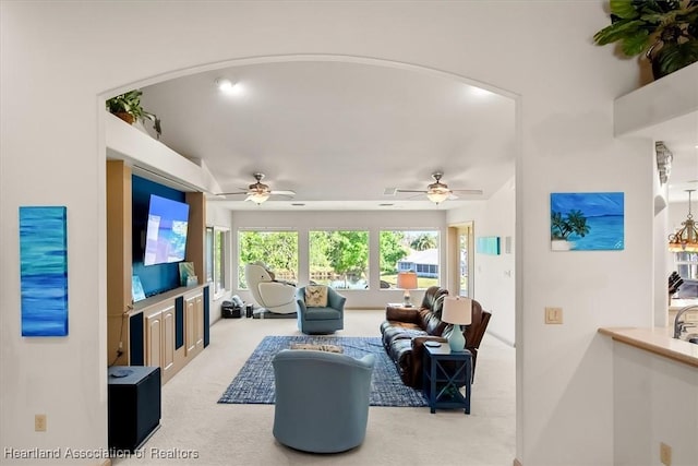 living room featuring light colored carpet and ceiling fan