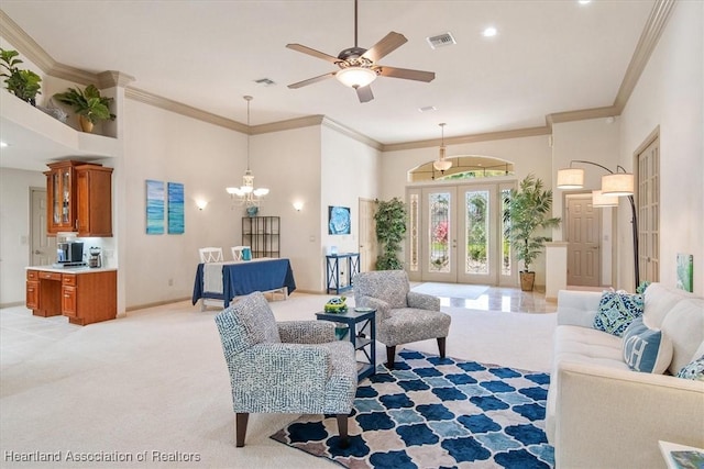 living area with crown molding, ceiling fan with notable chandelier, visible vents, and light carpet