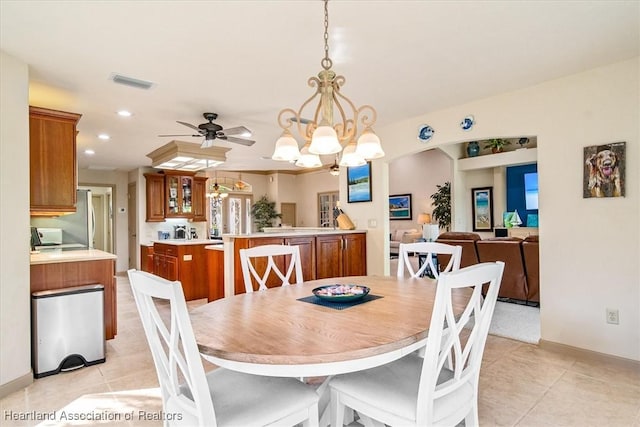 dining area with light tile patterned floors, visible vents, recessed lighting, and ceiling fan with notable chandelier