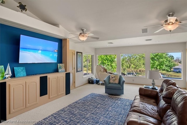 living area featuring visible vents, baseboards, carpet, and a ceiling fan