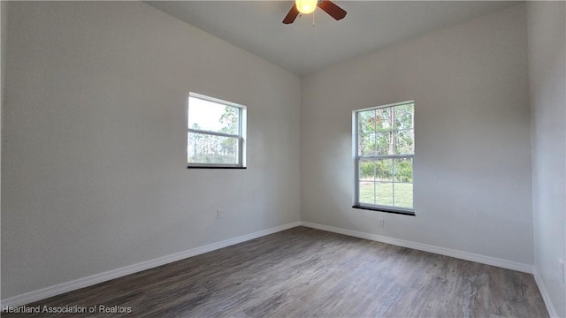 unfurnished room featuring ceiling fan, a healthy amount of sunlight, and dark hardwood / wood-style floors