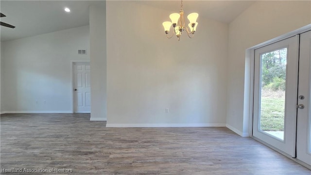 empty room featuring wood-type flooring, plenty of natural light, and french doors