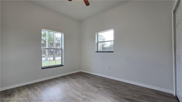 spare room with plenty of natural light, dark hardwood / wood-style floors, and ceiling fan