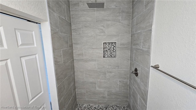 bathroom with tiled shower