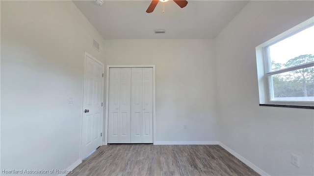 spare room featuring ceiling fan and light wood-type flooring