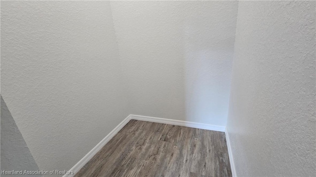 spacious closet with dark hardwood / wood-style floors