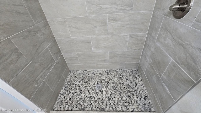 bathroom with a tile shower