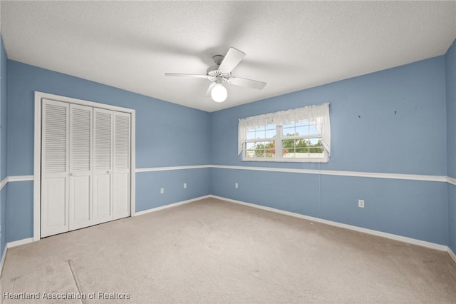 302 S Egret St, Sebring, FL 33870 - unfurnished bedroom featuring carpet, a closet, a textured ceiling, baseboards, and ceiling fan
