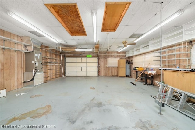 302 S Egret St, Sebring, FL 33870 - garage featuring water heater, heating unit, and wooden walls
